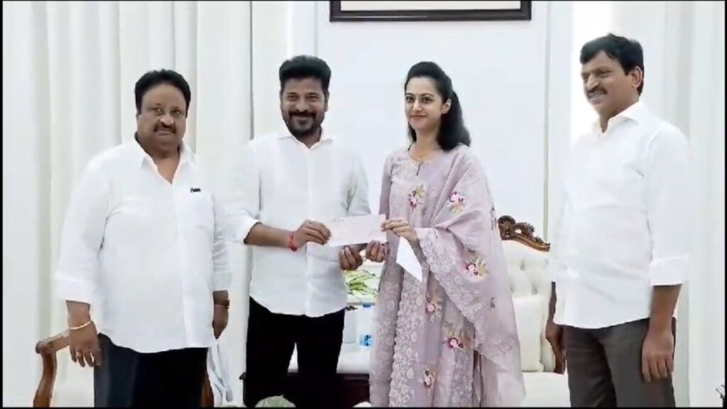 Balakrishna's daughter presenting the donation check to CM Revanth